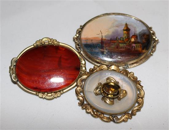 Two Victorian oval chalcedony set brooches, one with citrine and an oval pictorial brooch.